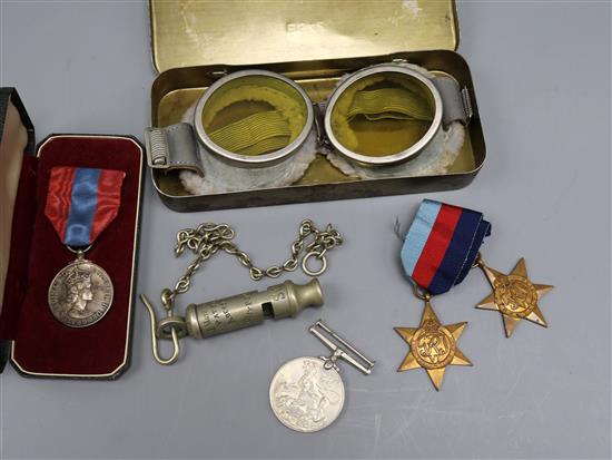 A pair of mid 20th century motorcycle goggles, a Scottish police whistle, three WWII medals and a cased Imperial Service Medal
